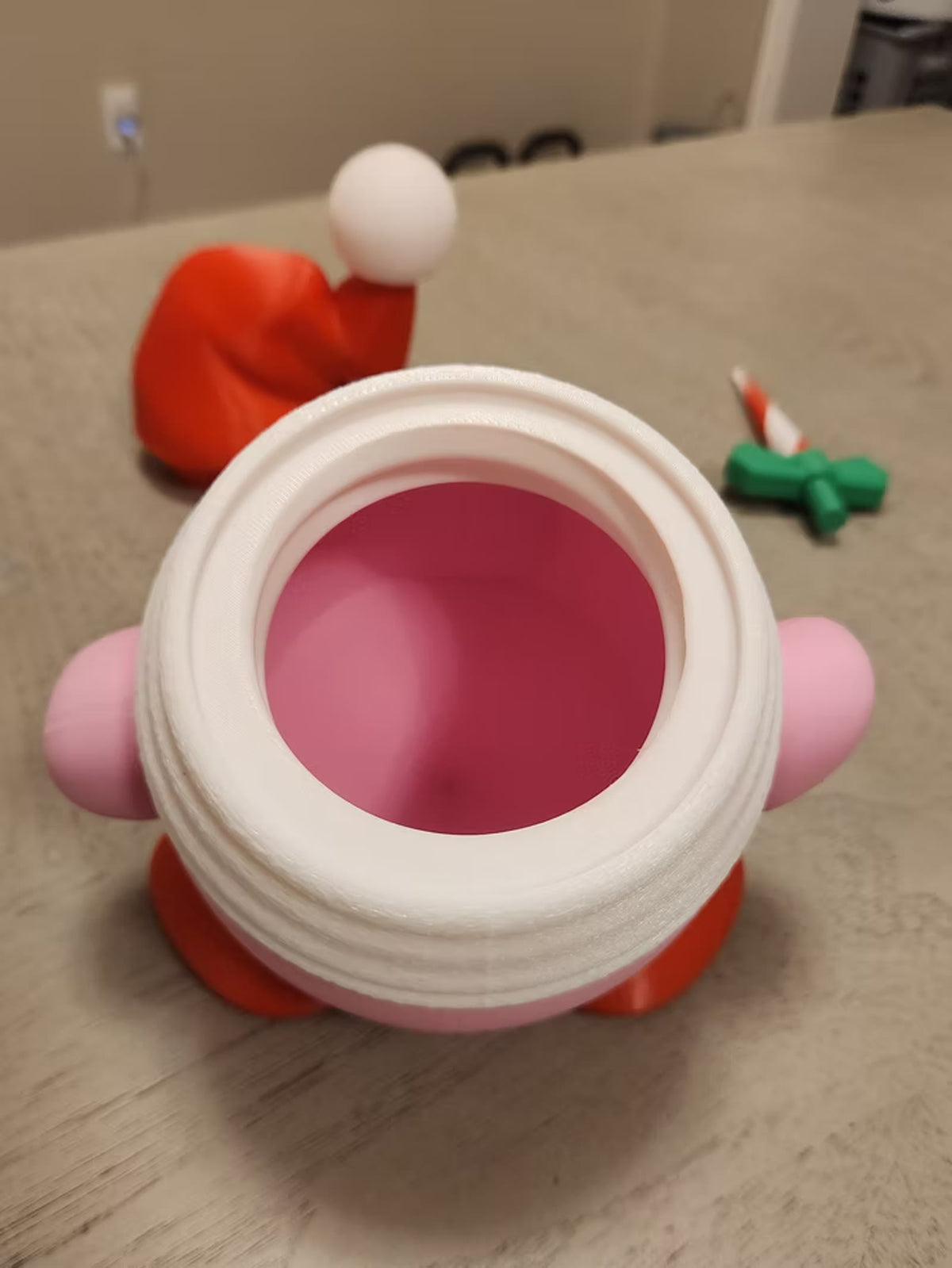 Santa KIRB with the hat twisted off, showing the hidden storage