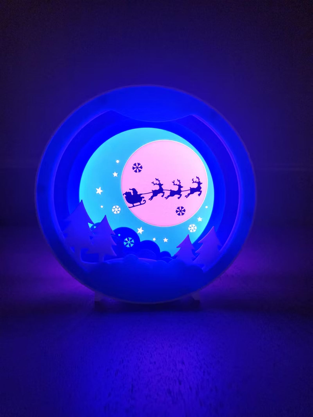 Sleigh night light glowing blue and pink