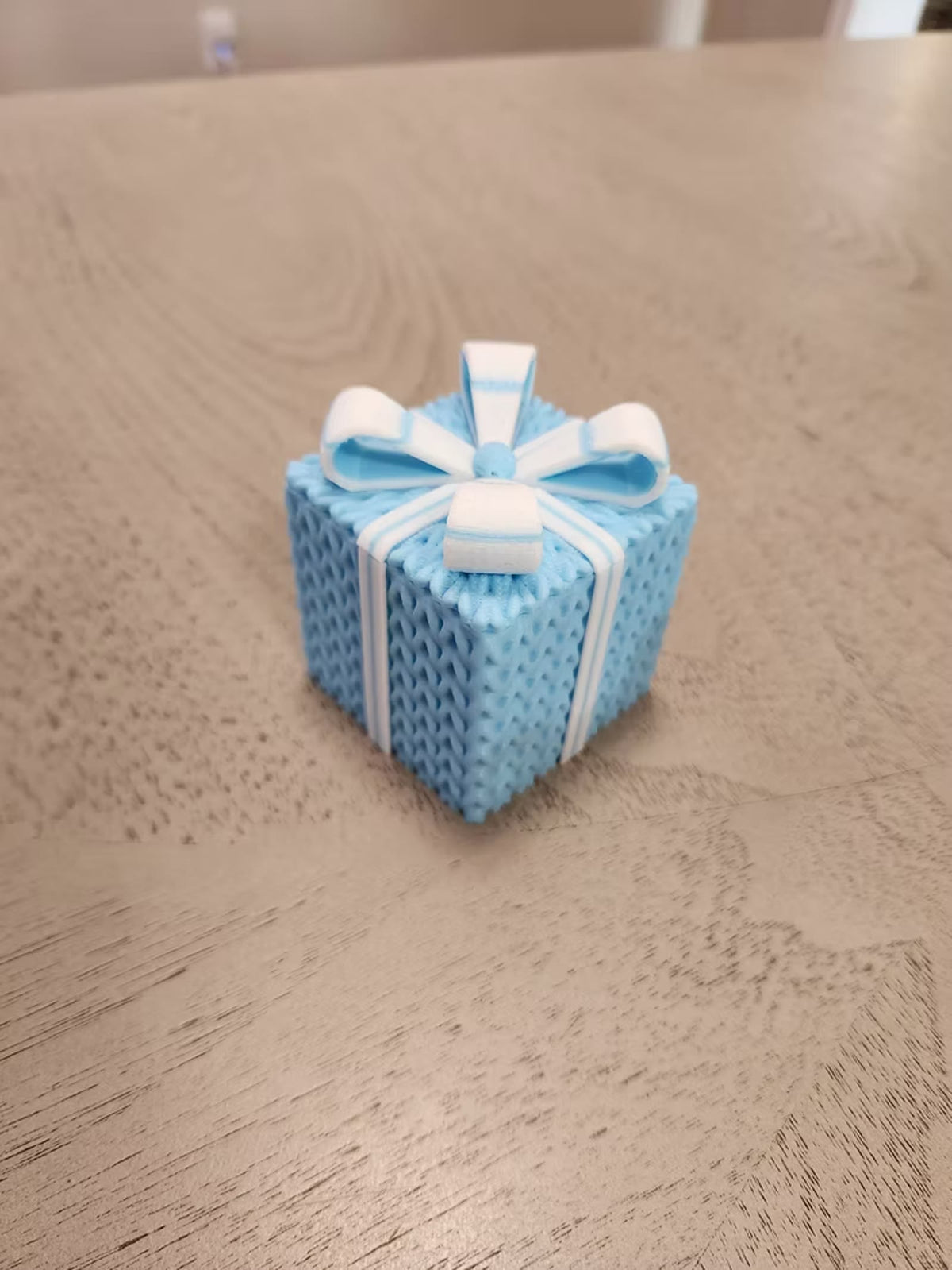 Light blue knitted gift box with a white bow