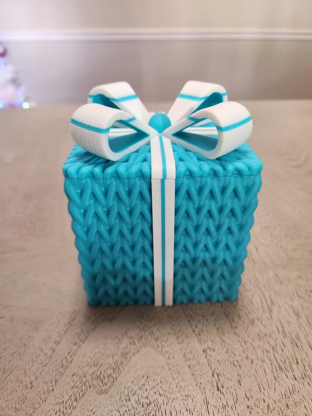 Teal knitted gift box, front view