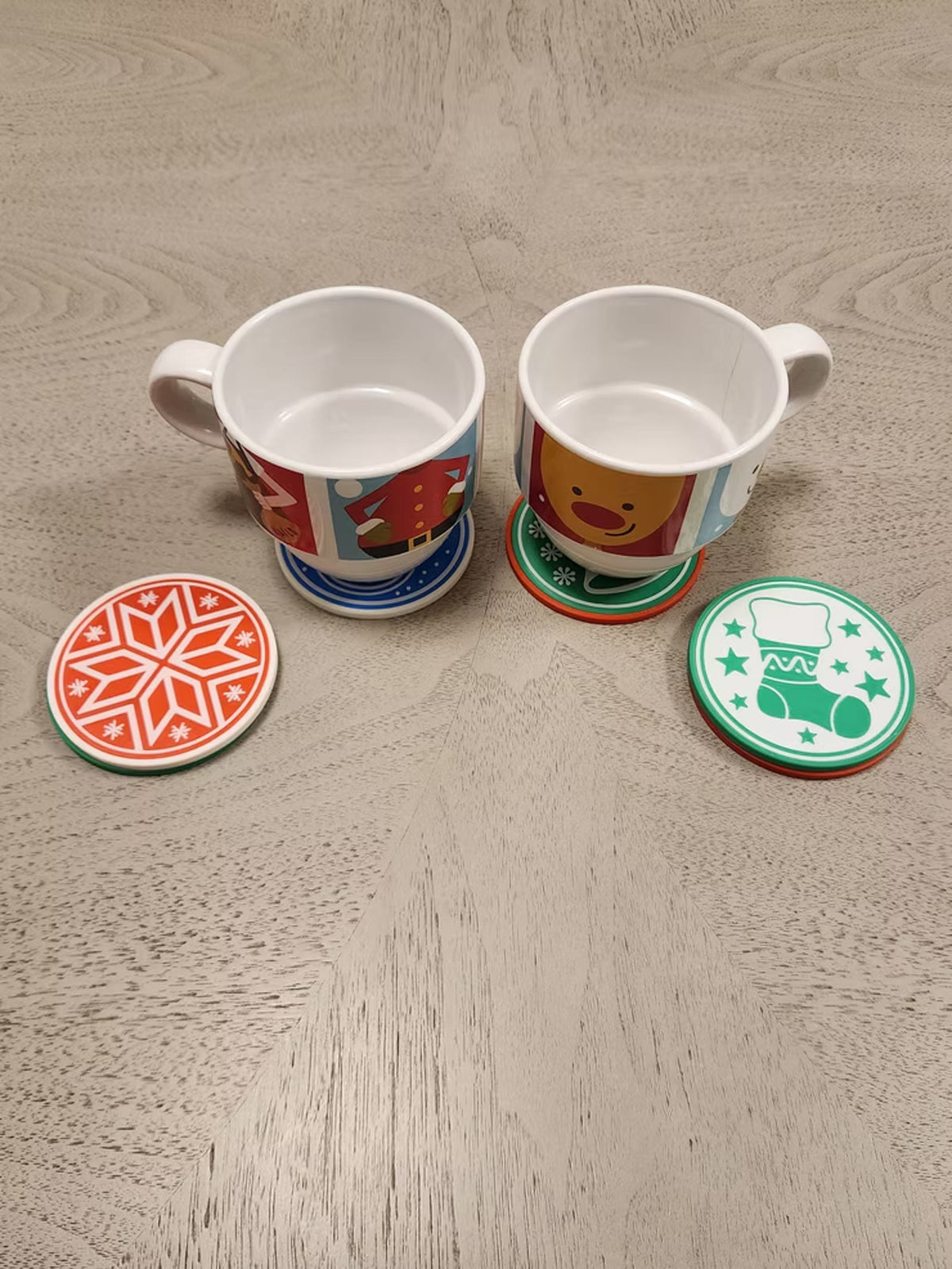 Holiday coasters used under two mugs