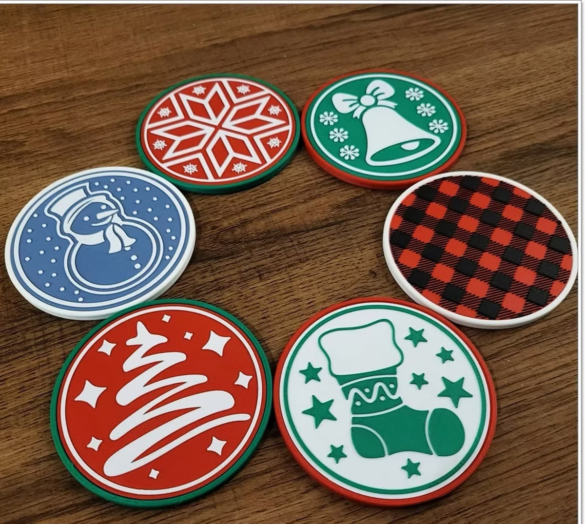 Six round Christmas coasters on a wood table